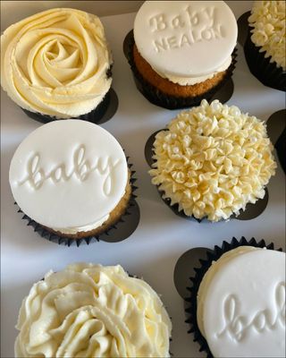 A box of baby
      shower themed cupcakes