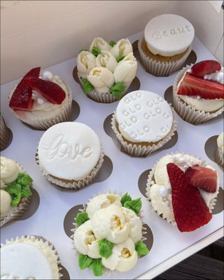 A box of cupcakes with
      fruit toppings