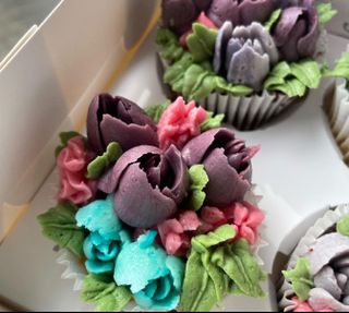 A box of cupcake
        that look like flowers