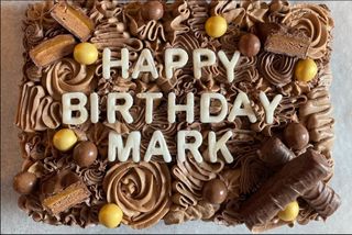 A cake that is decorated
      with the words, happy birthday mark